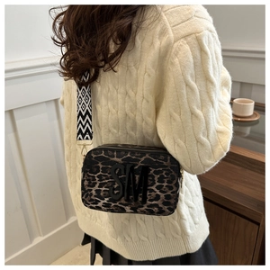 Chic leopard print crossbody bag with bold SM letter detail and patterned wide strap