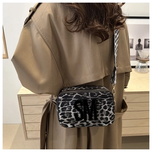 Detail of leopard print crossbody bag with SM logo and wide geometric shoulder strap
