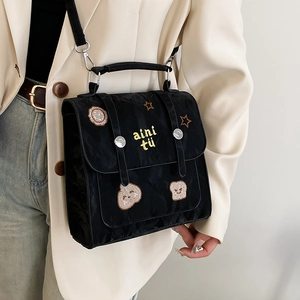Retro embroidered black nylon crossbody bag featuring cute cartoon patterns and top handle
