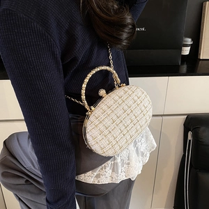 Elegant white tweed oval evening box bag with gold metal frame and pearl clasp
