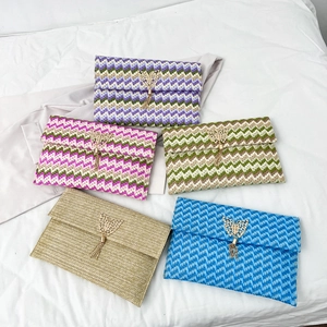 Bohemian straw envelope clutch bags with gold butterfly and fringe detail in five colors