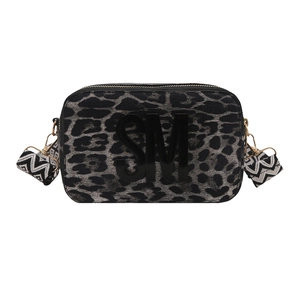 Chic leopard print crossbody camera bag with black SM logo and patterned woven strap