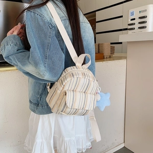Mini striped canvas backpack for women with star charm and front pocket detail