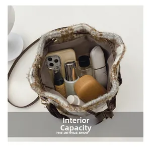 Internal capacity of the plaid bucket bag showing space for phone and cosmetics