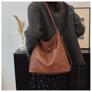 Close-up of caramel lychee grain tote bag with exterior pocket and adjustable strap