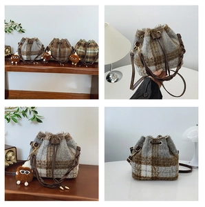 Detailed close-up of colorful checkered wool bucket bags with plush monster charm