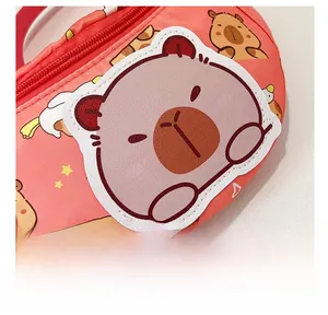 Close-up of coral pink chest bag with capybara embroidery and cartoon pattern