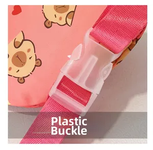 Detail of pink cartoon chest bag showing a durable plastic buckle and printed strap