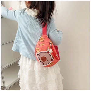 Rear view of a child wearing a coral pink cartoon bear crossbody bag with star patterns