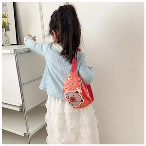 Close-up of girl wearing a pink cartoon bear chest bag with adjustable strap