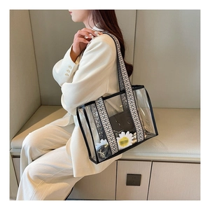 Detailed shot of transparent PVC tote bag with stylish geometric woven strap and inner pouch