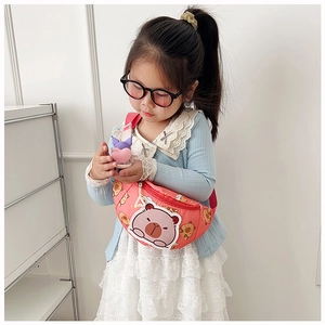 Detail of child wearing orange cartoon bear chest bag with adjustable strap in daily use