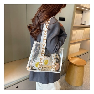 Transparent PVC tote bag with letter strap showing internal daisy pouch and spacious capacity