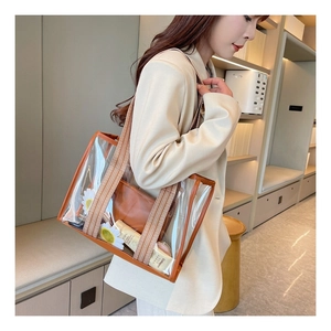 Close-up of a large jelly tote bag featuring bohemian geometric wide straps and inner pouch