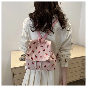 Pink corduroy mini backpack with strawberry embroidery and drawstring flap closure
