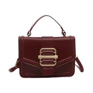 Deep red vintage handbag with gold clasp and top handle in a minimalist square design