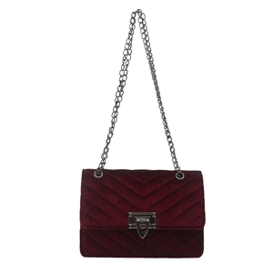 Burgundy velvet crossbody bag with V-shaped quilting and silver chain strap