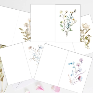 Close-up of minimalist folded birthday cards with watercolor floral illustrations