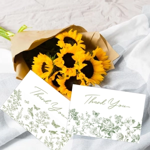 Detail of floral thank you greeting cards with nature illustrations on white fabric