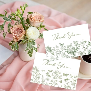 Detail of floral Thank You cards on pink silk with roses and a white coffee cup