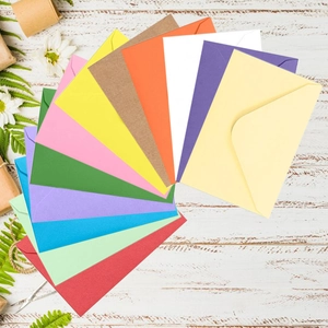 Colorful mini kraft paper envelopes set with V-flap for party invitations on wooden background