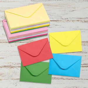 Detailed stack of vibrant multi-color kraft paper mini envelopes for party invitations