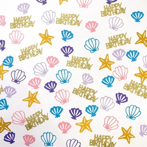 Colorful starfish and shell confetti with Happy Birthday lettering for party decoration