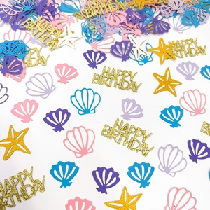Colorful starfish and seashell confetti with Happy Birthday lettering for party decor