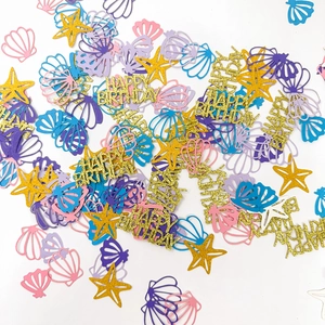 Mix of colorful starfish and seashell confetti with Happy Birthday cutout decorations