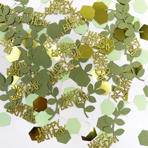 Green birthday party confetti set with gold leaf shapes and hexagonal paper table decor