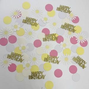 Mix of daisy flowers, colorful round dots and golden Happy Birthday confetti for party decor
