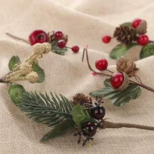 Close-up of Christmas decorative branch with red berries, pine cones and deer charm