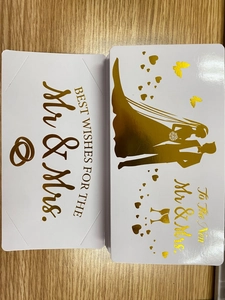 Detail of white wedding cards with gold foil lettering for the new Mr & Mrs