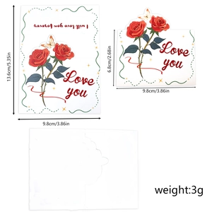 Detail view of red rose greeting card with Love You text and white envelope packaging