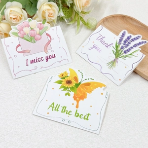 Floral greeting cards with tulip, sunflower, and lavender designs in a gift setting