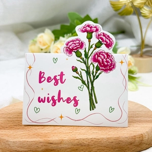 Detailed view of carnation card on wooden stand with Best Wishes text for Mother's Day