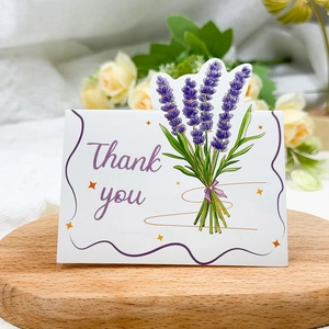 Detail of Thank You card with lavender bouquet on a wooden stand with roses