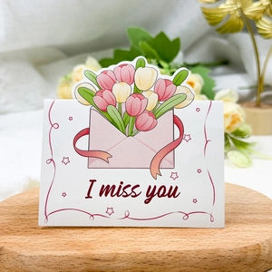Detail of tulip illustration card with I Miss You text on a wooden tray setting