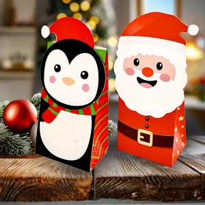Detail of Christmas themed penguin and Santa Claus greaseproof paper gift bags