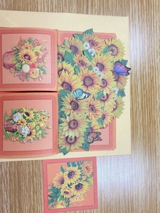 Detailed 3D pop-up greeting card featuring sunflower paper cut art and colorful butterflies