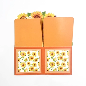 Detail of 3D pop-up sunflower card with vibrant orange paper and laser-cut layers