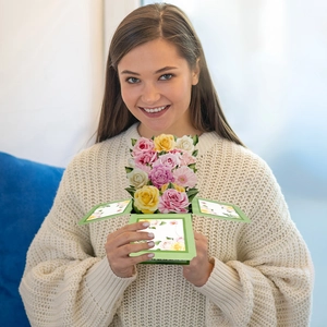Detail of 3D pop-up flower bouquet card featuring colorful roses and green leaves