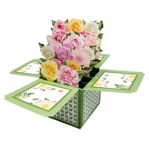 Detailed macro of 3D pop-up flower box greeting card with pink roses and daisies
