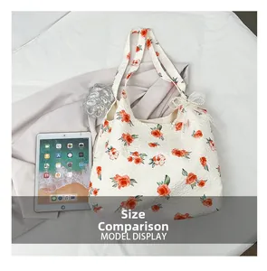 Floral canvas tote bag size comparison with a tablet showing the spacious interior