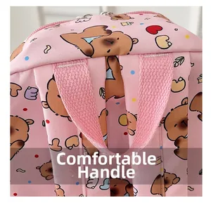 Detail shot of the comfortable handle and cartoon pattern on pink school backpack