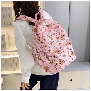 Close-up of pink backpack featuring cute cartoon bear print and wide adjustable straps