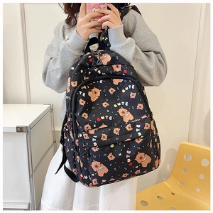 Detail of cute cartoon bear print and CUTE colorful lettering on black nylon backpack