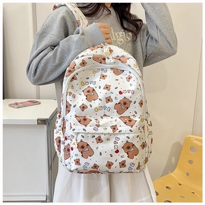 Detail of cute white backpack featuring brown bear patterns and multi-color polka dots