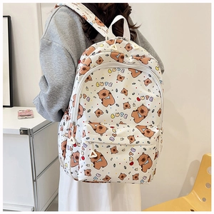 Detail of cute white backpack featuring brown bear patterns and letters on back