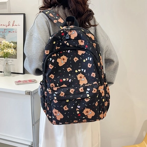 Black backpack featuring cute bear patterns and CUTE text with large capacity storage